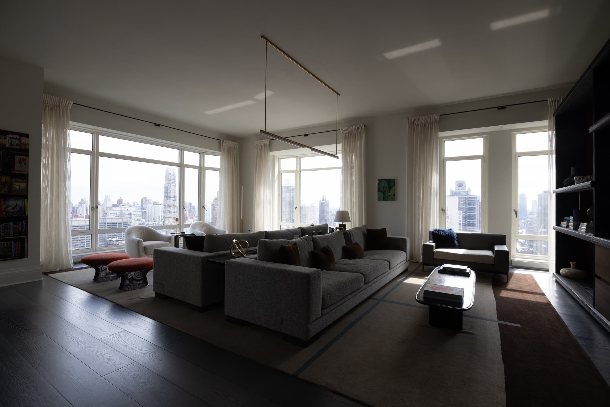 Open-plan living room with sectional sofas and floor-to-ceiling windows, original unedited photo