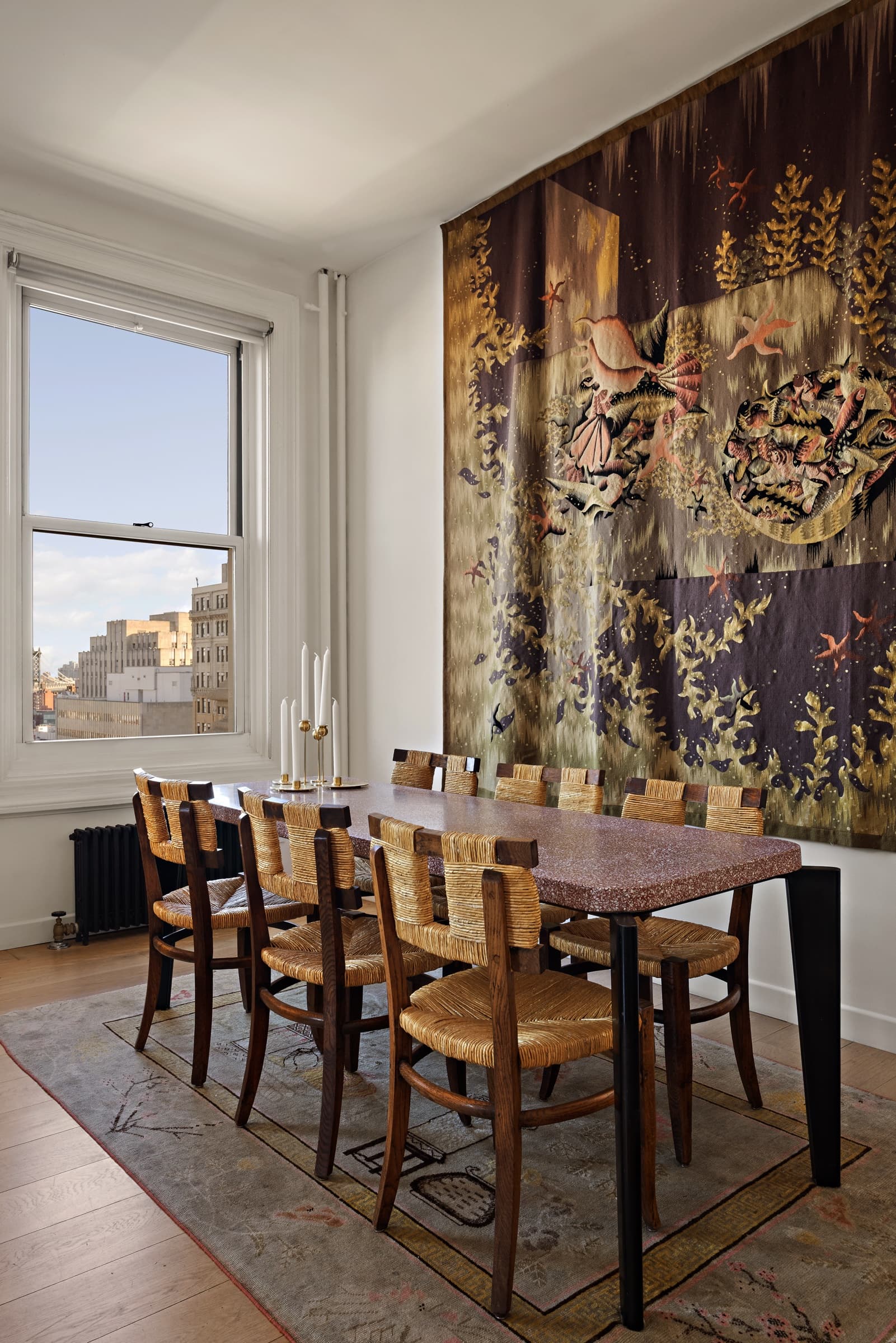 The same dining room after an editorial edit: tapestry color and texture preserved, with natural window light