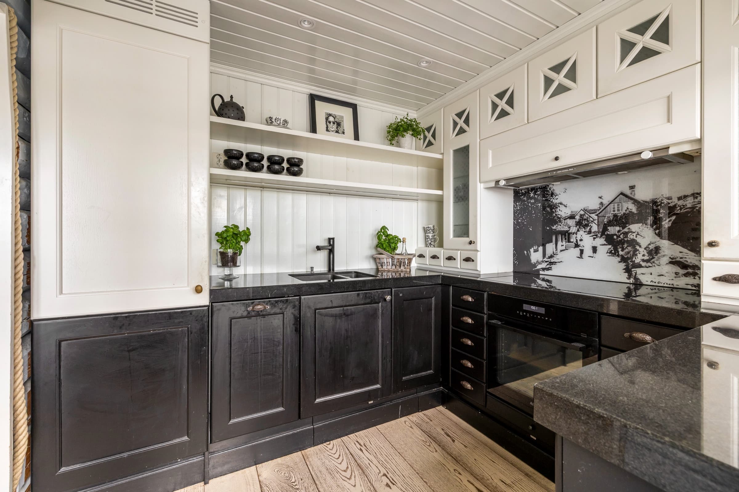 The same kitchen after editing: clean whites, balanced exposure and natural wood floor tones
